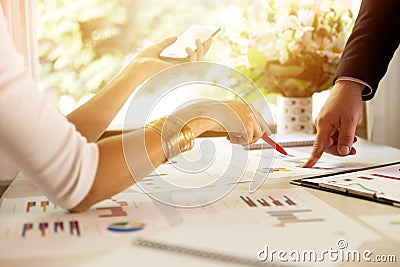 Team members discussing data at meeting. Graphs and charts on table. Business situation Stock Photo