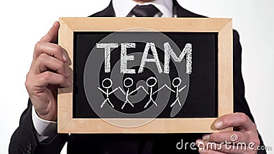 Team members drawn on blackboard in businessman hands, cooperation on project Stock Photo