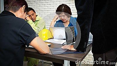 Team members worry anxious when Chief standing hiting table Stock Photo