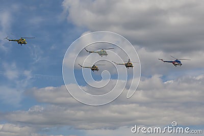 Team of MI-2 Helicopters Performing Elements in Air In Front of Spectators During Aviation Sport Event Editorial Stock Photo