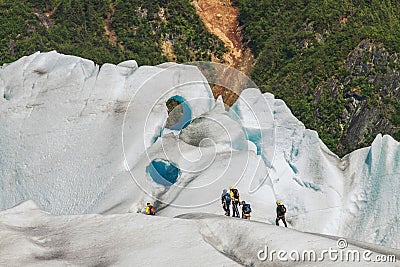 Team of People Climbing Glacier Stock Photo