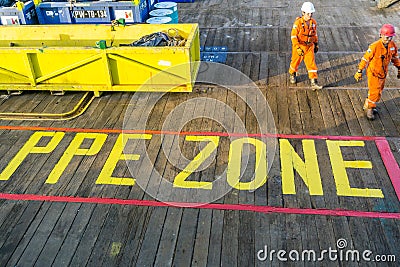 A team of rigger lifting an anchor from a construction work barge Editorial Stock Photo