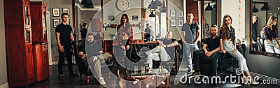 Team from seven barbers in modern barbershop. Stock Photo