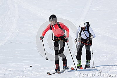 Team ski mountaineers climb on mountain on skis strapped to climbing skins Editorial Stock Photo