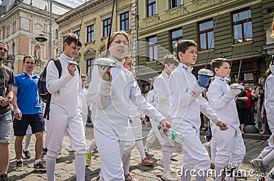 LVIV, UKRAINE - MAY 2018: Team of sportsmen in fencing goes in sports suits in the center of the city at the parade Editorial Stock Photo