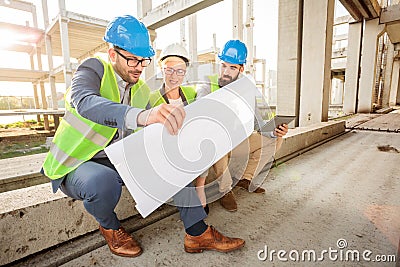 Team of successful young architects looking at floor plans during a meeting Stock Photo