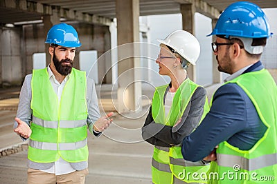 Bearded young architect is explaining project details and future plans to his colleagues Stock Photo