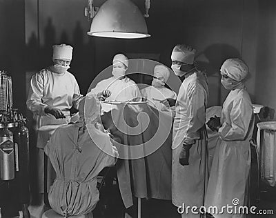 Team of surgeons perform operation Stock Photo