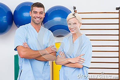 Team of therapists with arms crossed smiling at camera Stock Photo