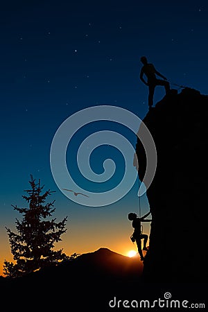 Team of two mountaineers roped climb the mountain. Stock Photo