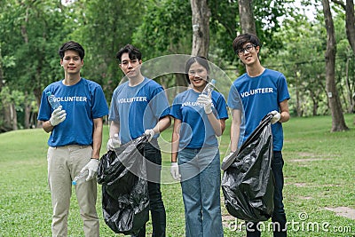 Team volunteers collecting garbage in public park. Environmental protection Concept Stock Photo