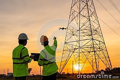 Team work of Engineers location help Technician use drone to fly inspections at the electric power station to view the planning Stock Photo