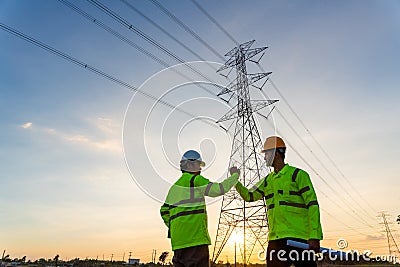 Team work of Engineers and Technician join hands for success after work inspections at the electric power station, electricity Stock Photo