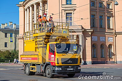 A team of workers on the car of the city electric transport emergency service Editorial Stock Photo