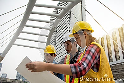 Team of Young Females and Male Engineers Working on Building pro Stock Photo