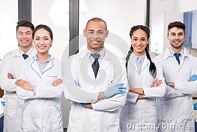 Team of young professional doctors standing together in laboratory posing Stock Photo