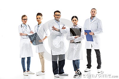 Team of young professional doctors in white coats standing together Stock Photo