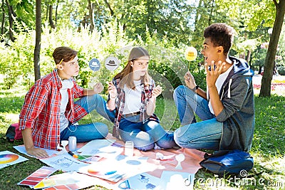 Team of young promising entrepreneurs using thinking hats Stock Photo