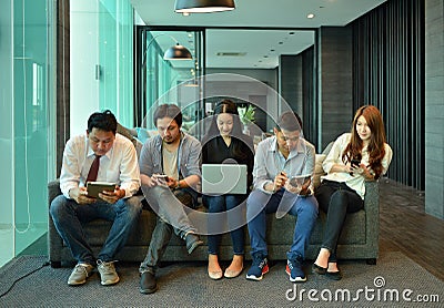 Teamwork of Asian business people are not interested in each other Stock Photo