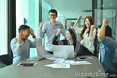 Teamwork of Asian business people succeed a project, tag team Stock Photo