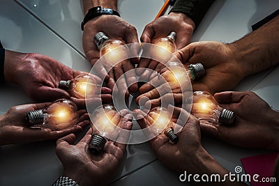 Teamwork and brainstorming concept with businessmen that share an idea with a lamp. Concept of startup Stock Photo