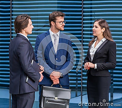 Teamwork and business concept. Confident businesspersons having conversation about banking and financial markets in Stock Photo