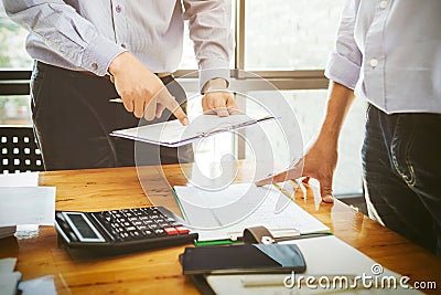 Teamwork business officer working hard investing financial reports and calculating colleagues for successful project. Stock Photo