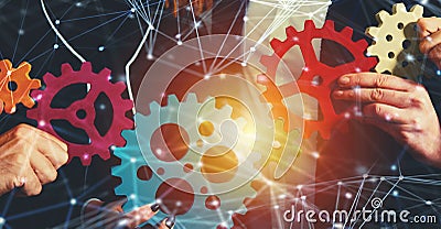 Business team connect pieces of gears. Teamwork, partnership and integration concept with network effect Stock Photo