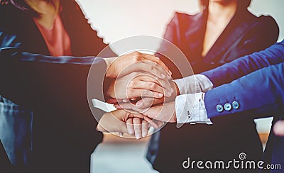 Close-up of young business people shaking hands. Demonstrates excellent work. laying hands to encourage work Unity and Stock Photo