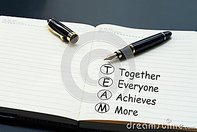 Teamwork concept. luxury pen writing word Teamwork, Together, Everyone, Achieves and More on the daily notebook Stock Photo