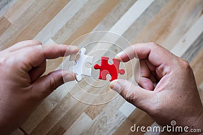 Teamwork concept using white and red puzzle pieces. Stock Photo