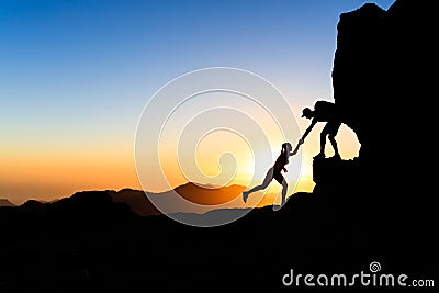 Teamwork couple climbing helping hand Stock Photo