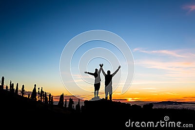 Teamwork couple climbing and reaching mountain peak Stock Photo