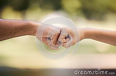 Teamwork, fist bump and people with outdoor support, collaboration and team building mission or agreement. Man, woman Stock Photo