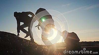 Teamwork help business three men hold hand travel silhouette concept. group of tourists lends a helping hand climb the stock video footage Teamwork help business three men hold hand travel silhouette concept. group of tourists lends a helping hand climb the stock video footage