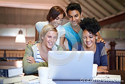 Teamwork, laptop or students studying in college, university library or school campus for education. Group, elearning or Stock Photo