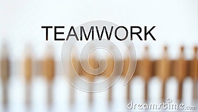 Teamwork sign above line of toy human figures Stock Photo