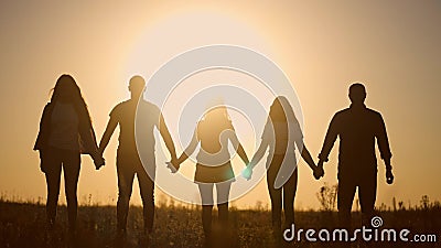 teamwork. team community a holding hands together silhouette at unity sunset. group of people hands. teamwork of workers Stock Photo
