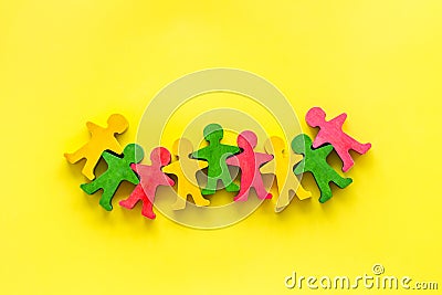 Teamwork, teambuilding concept. Wooden figures of people on yellow background top view Stock Photo