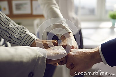 Closeup hand together of business team bumping fist jointing standing in office Stock Photo