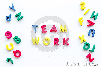 Teamwork training concept. Text teamwork lined with colored letters near toy letters on white background top view space Stock Photo