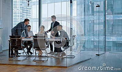 Teamwork: young business people discussing holding a presentation in modern office Stock Photo