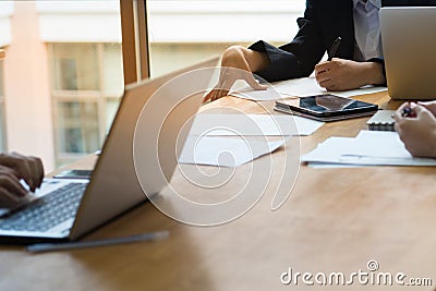 Teamwork.young businesswomen sitting at table write down on paper and other one your laptop and smartphone discuss business Stock Photo