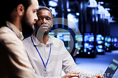 Developers fixing server system failures Stock Photo
