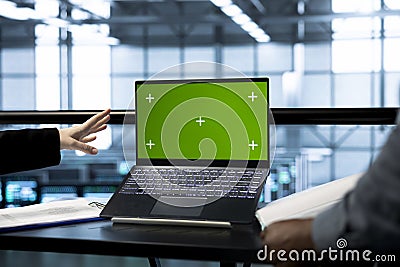 Teamworking technicians in data center using mockup notebook Stock Photo