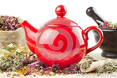 Teapot, mortar and pestle with healing herbs Stock Photo