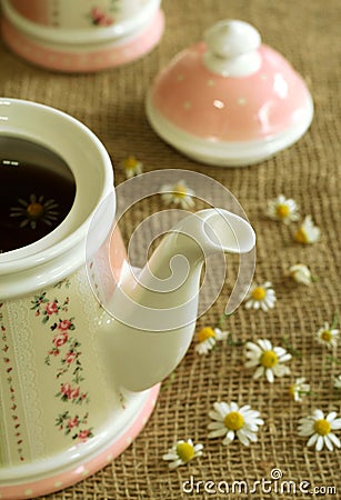 teapot with soothing herbal chamomile tea. Stock Photo