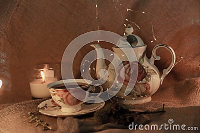 A teapot and tea with candle and rustic details Stock Photo