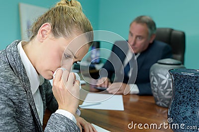 Tearful woman in meeting with funeral director Stock Photo