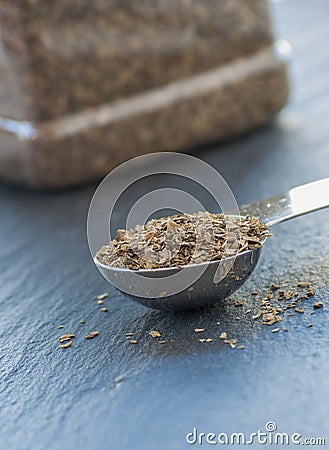 A teaspoon full of dried basil leaf Stock Photo